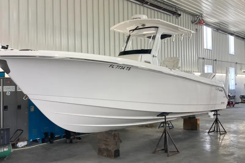 Slide: The Image of 2023 Edgewater 262CC boat in a storage facility. - 17