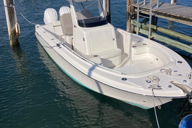 Slide: The Image of 2023 Edgewater 262CC boat docked on clear blue water. - 20