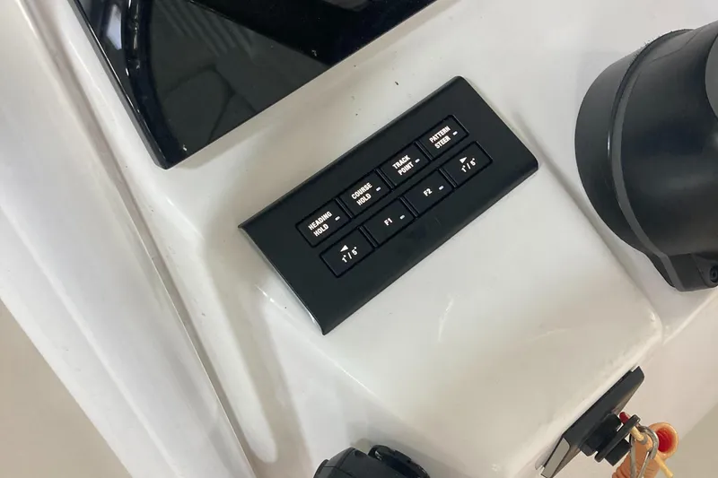 Slide: The Image of Control panel of a 2023 Edgewater 262CC boat with various switches. - 28