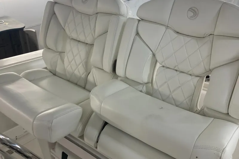 Slide: The Image of 2023 Edgewater 262CC boat with luxurious white leather seating. - 33