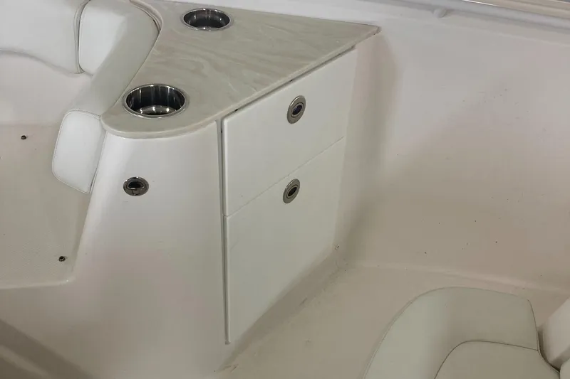 Slide: The Image of 2023 Edgewater 262CC boat interior with storage compartments and cup holders. - 34