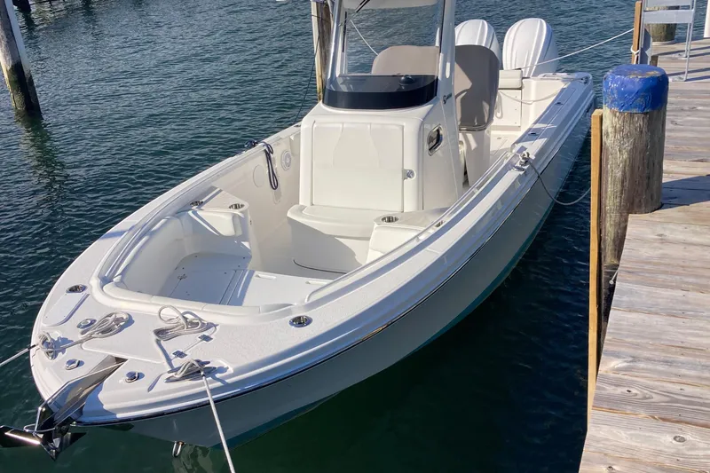 Slide: The Image of 2023 Edgewater 262CC boat docked on calm water. - 40