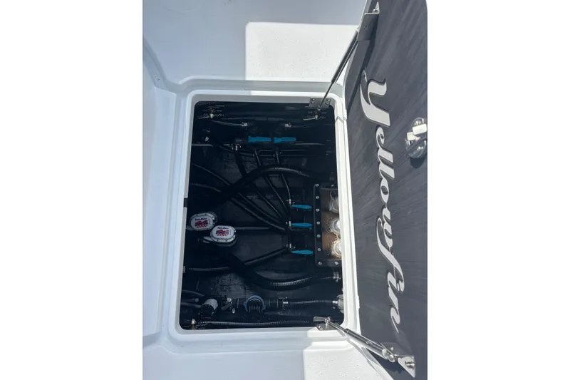 Slide: The Image of 2026 Yellowfin 39 Offshore boat cruising on a calm river near residential area. - 18