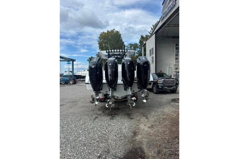 Slide: The Image of 2026 Yellowfin 39 Offshore boat cruising on a calm river near houses. - 19