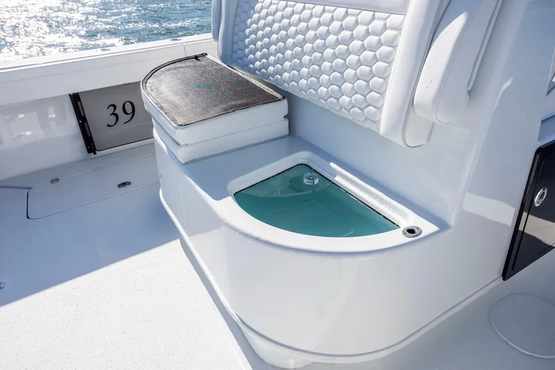 Slide: The Image of 2026 Yellowfin 39 Offshore boat interior with seating and storage compartment. - 30