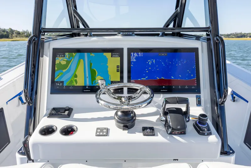 Slide: The Image of 2026 Yellowfin 39 Offshore boat dashboard with dual Garmin displays and steering wheel. - 33