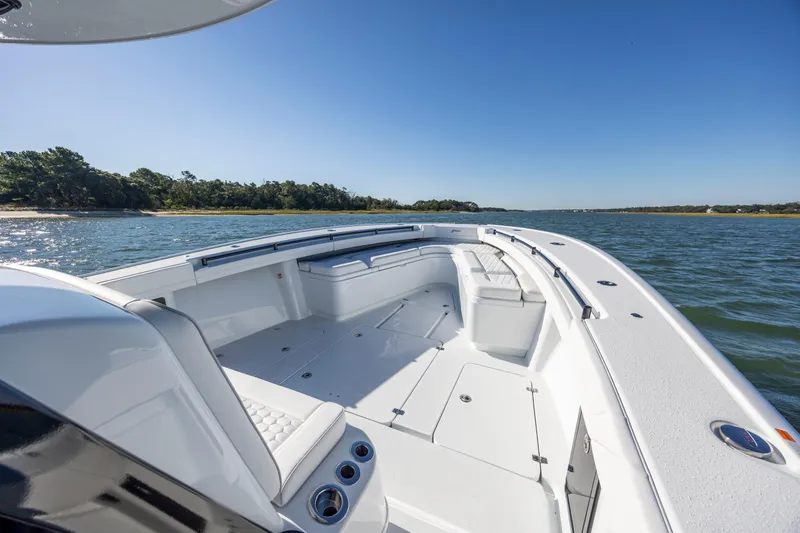 Slide: The Image of 2026 Yellowfin 39 Offshore boat on calm water, clear sky, and scenic shoreline. - 37