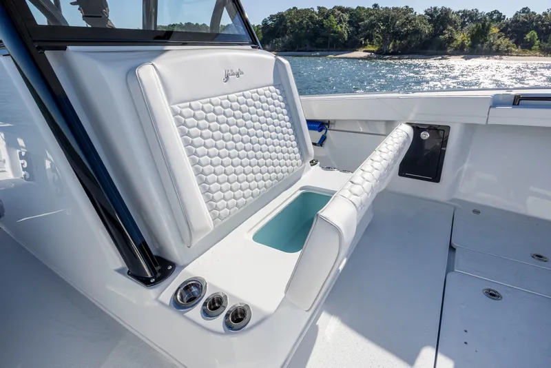 Slide: The Image of 2026 Yellowfin 39 Offshore boat interior with white cushioned seating and ocean view. - 40