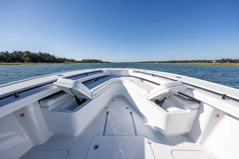 Slide: The Image of 2026 Yellowfin 39 Offshore boat on calm water, featuring spacious seating and clear blue skies. - 41