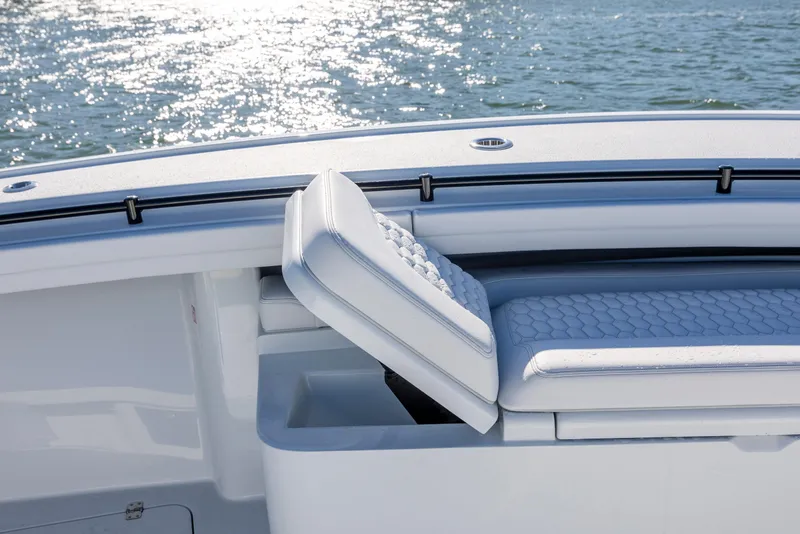 Slide: The Image of 2026 Yellowfin 39 Offshore boat with cushioned seating and storage, on sparkling water. - 42