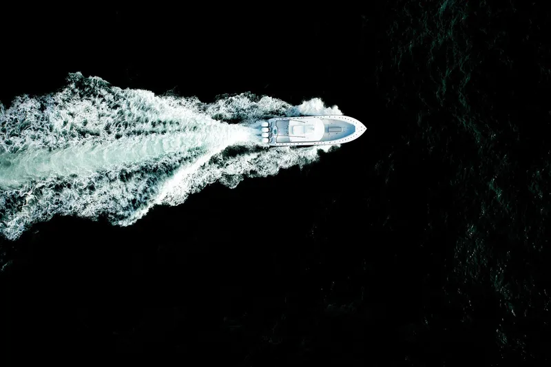 Slide: The Image of 2026 Yellowfin 39 Offshore boat cruising on open water, rear view. - 6