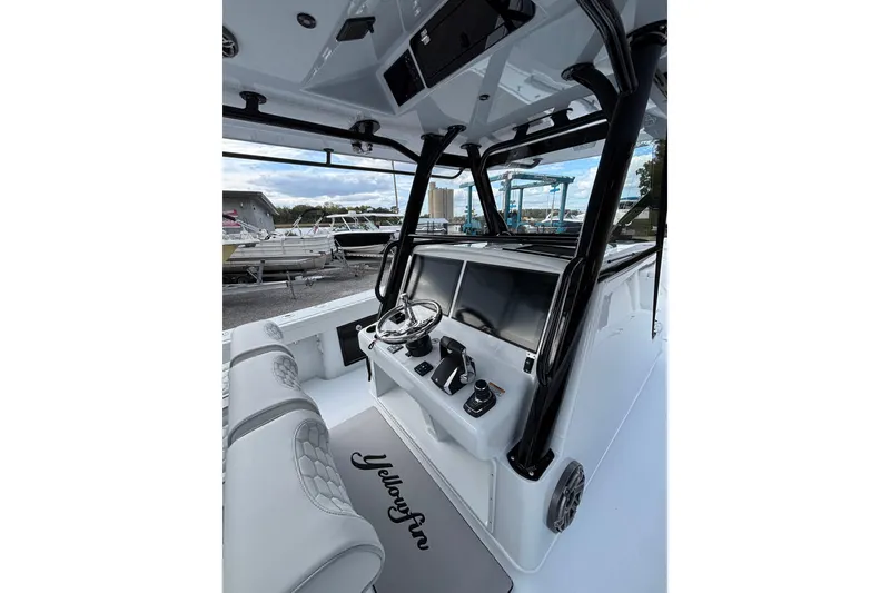 Slide: The Image of 2026 Yellowfin 39 Offshore boat cruising on a calm lake. - 8