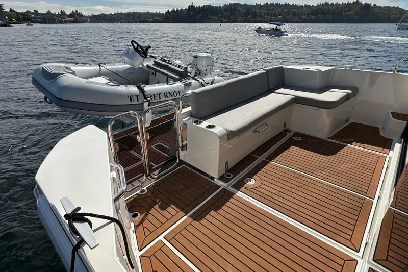 Slide: The Image of 2024 Beneteau Swift Trawler 41 Sedan with spacious deck and tender boat. - 13
