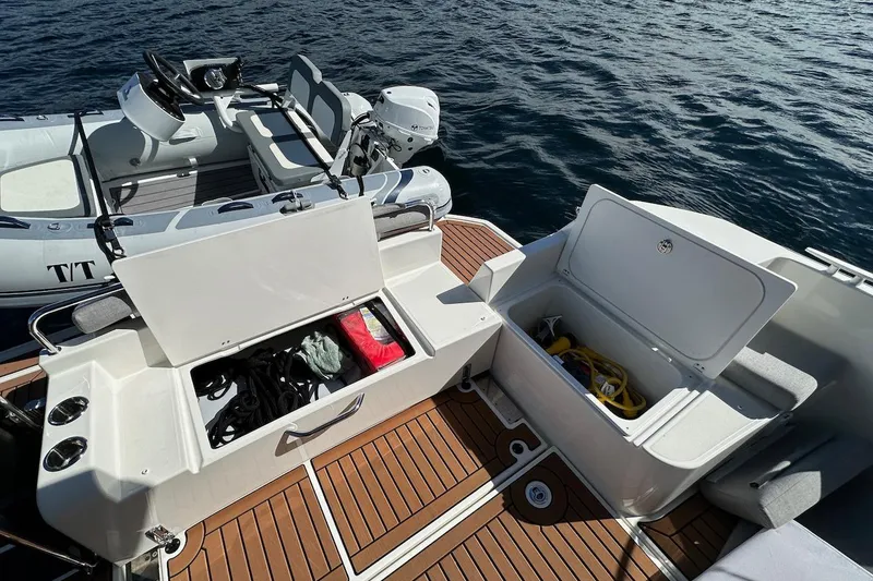 Slide: The Image of 2024 Beneteau Swift Trawler 41 Sedan deck with storage compartments and tender boat. - 16