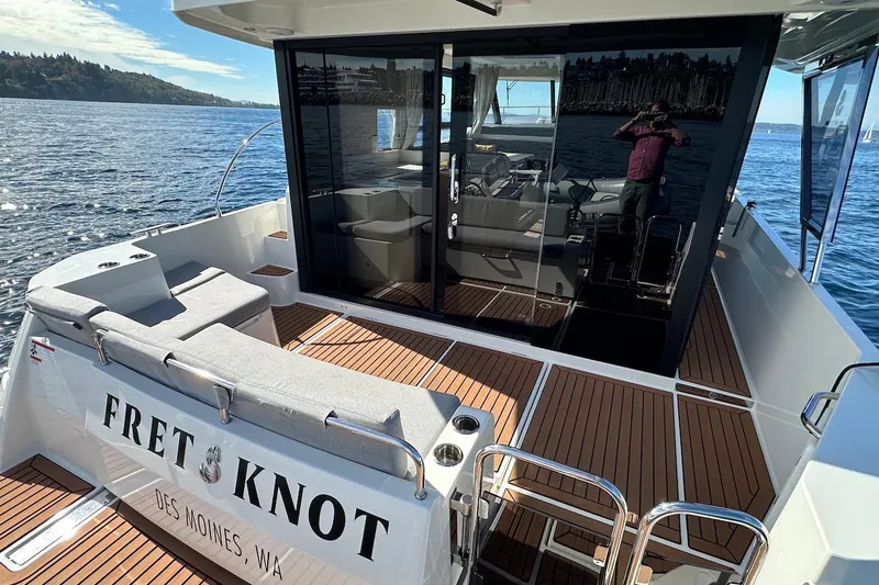 Slide: The Image of 2024 Beneteau Swift Trawler 41 Sedan on water, featuring spacious deck and elegant design. - 19