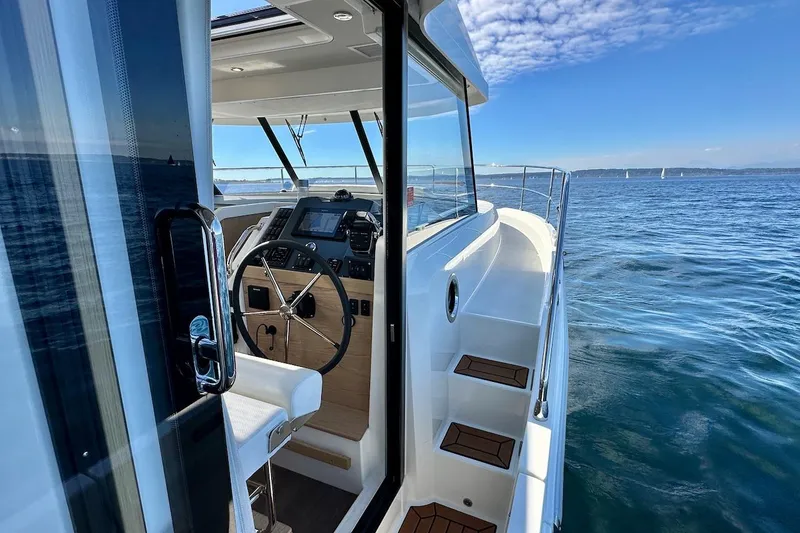 Slide: The Image of 2024 Beneteau Swift Trawler 41 Sedan, showcasing helm and ocean view. - 21