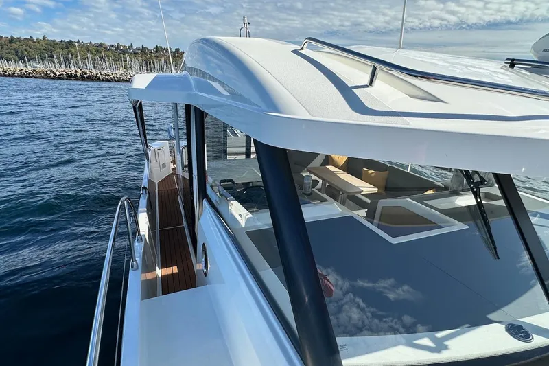Slide: The Image of 2024 Beneteau Swift Trawler 41 Sedan on water, showcasing sleek design and spacious deck. - 29
