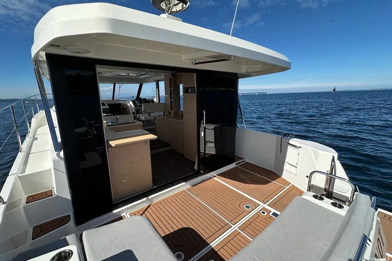 Slide: The Image of 2024 Beneteau Swift Trawler 41 Sedan, spacious deck, open sea view. - 30