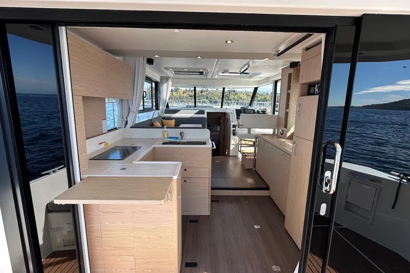 Slide: The Image of Interior of 2024 Beneteau Swift Trawler 41 Sedan with modern kitchen and ocean view. - 32