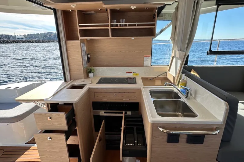 Slide: The Image of Modern kitchen interior of 2024 Beneteau Swift Trawler 41 Sedan with ocean view. - 35