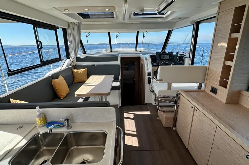 Slide: The Image of Interior of 2024 Beneteau Swift Trawler 41 Sedan with modern seating and ocean view. - 40