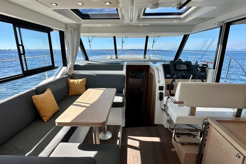 Slide: The Image of Interior of 2024 Beneteau Swift Trawler 41 Sedan with modern seating and navigation area. - 41