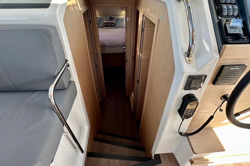 Slide: The Image of Interior view of 2024 Beneteau Swift Trawler 41 Sedan, featuring stairs and cabin entrance. - 52