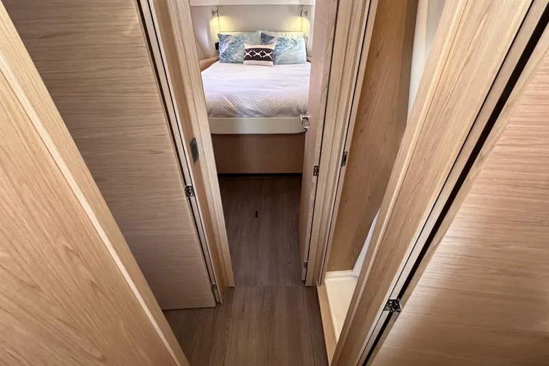 Slide: The Image of 2024 Beneteau Swift Trawler 41 Sedan interior with cozy bedroom and wooden finish. - 54