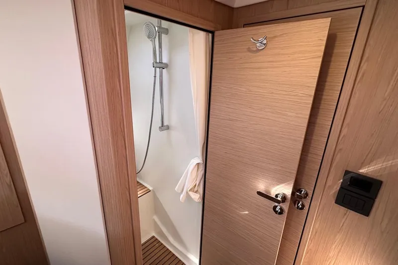 Slide: The Image of 2024 Beneteau Swift Trawler 41 Sedan shower with wooden accents and modern fixtures. - 60