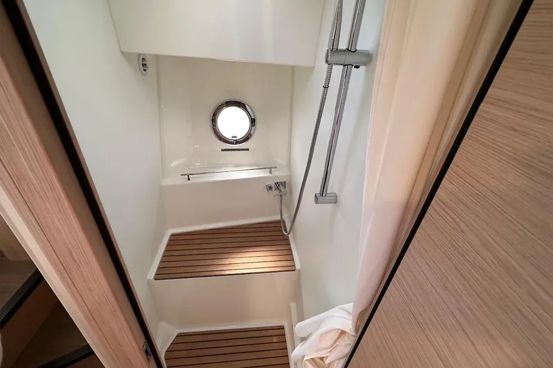 Slide: The Image of Shower area in 2024 Beneteau Swift Trawler 41 Sedan with wooden flooring and porthole. - 61