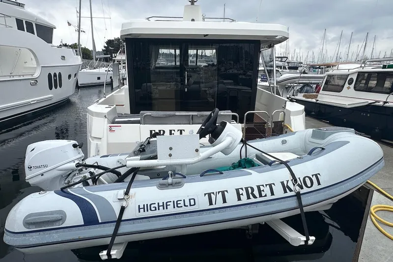 Slide: The Image of 2024 Beneteau Swift Trawler 41 Sedan with Highfield tender at marina. - 7