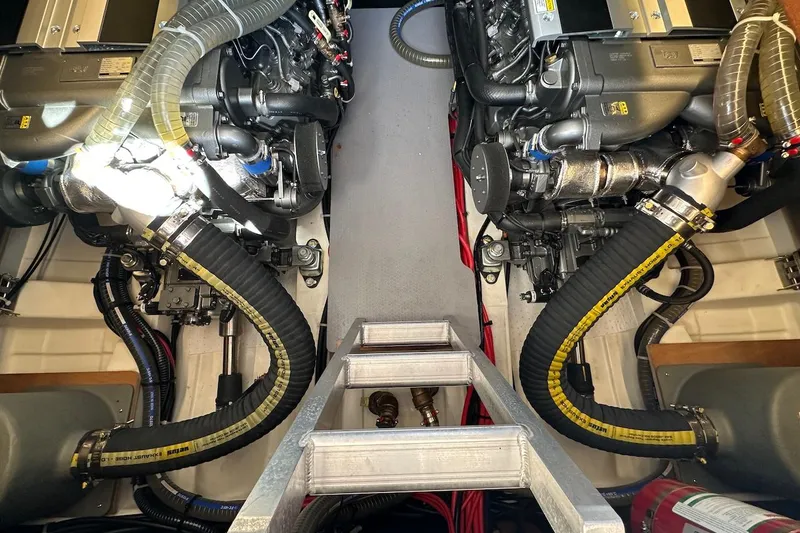Slide: The Image of Engine room of 2024 Beneteau Swift Trawler 41 Sedan with dual engines and hoses. - 77