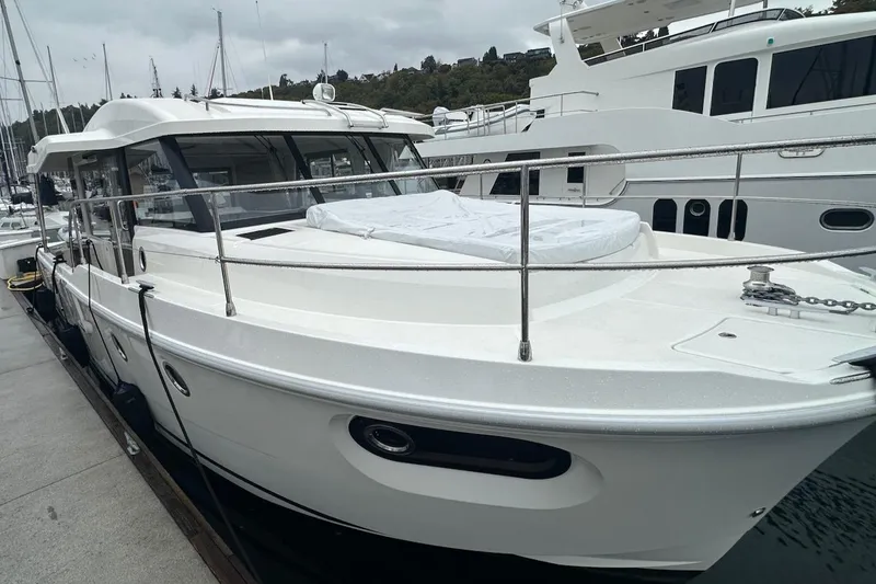 Slide: The Image of 2024 Beneteau Swift Trawler 41 Sedan docked at marina, showcasing sleek design. - 9