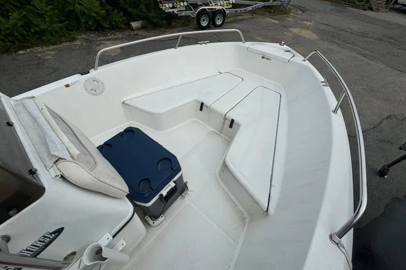 Slide: The Image of 2000 Hydra-Sports 180 Seahorse CC boat interior with seating and cooler. - 11