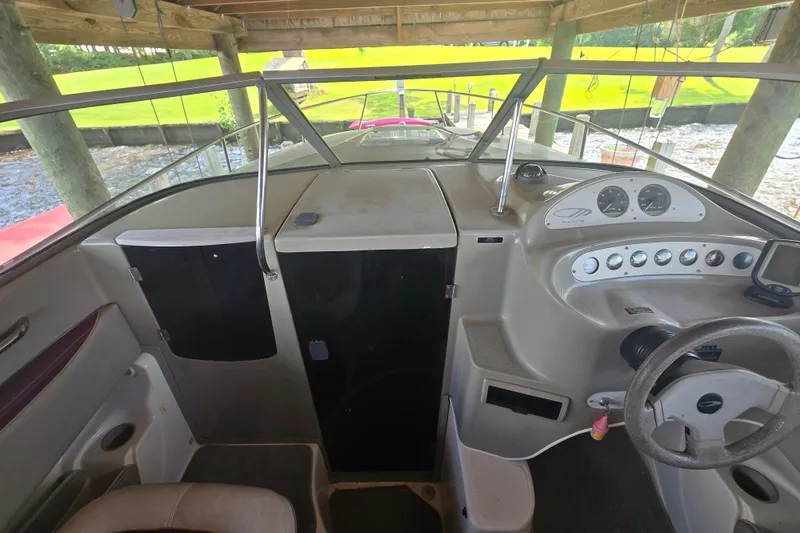 Slide: The Image of 1995 Maxum 2300 SC boat interior with steering wheel and dashboard controls. - 16