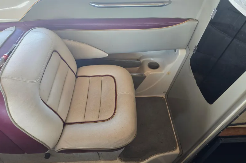 Slide: The Image of Interior seating of a 1995 Maxum 2300 SC boat, featuring cushioned upholstery. - 17