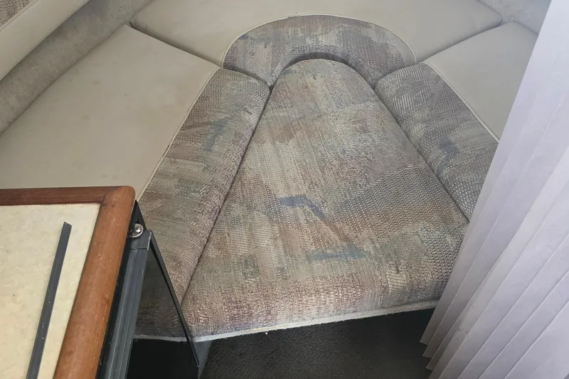 Slide: The Image of Interior cabin of a 1995 Maxum 2300 SC boat with cushioned seating. - 19