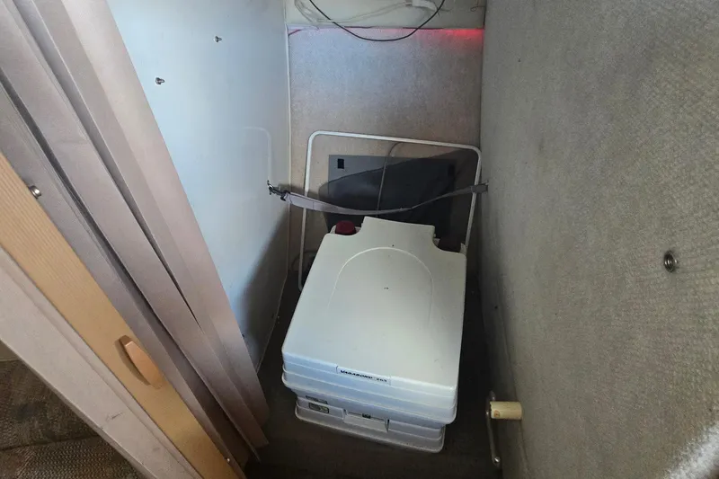 Slide: The Image of Interior of a 1995 Maxum 2300 SC boat with portable toilet. - 21