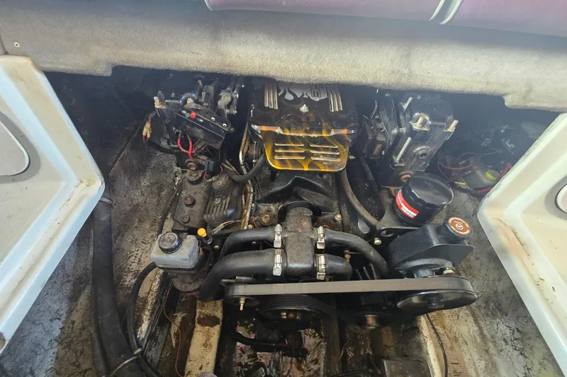 Slide: The Image of Engine compartment of a 1995 Maxum 2300 SC boat, showing detailed mechanical components. - 24