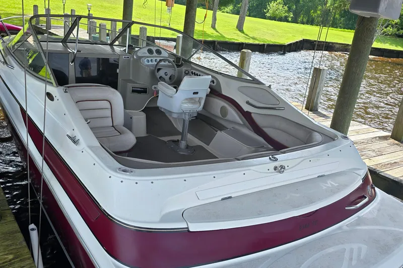 Slide: The Image of 1995 Maxum 2300 SC boat docked, featuring spacious seating and sleek design. - 4