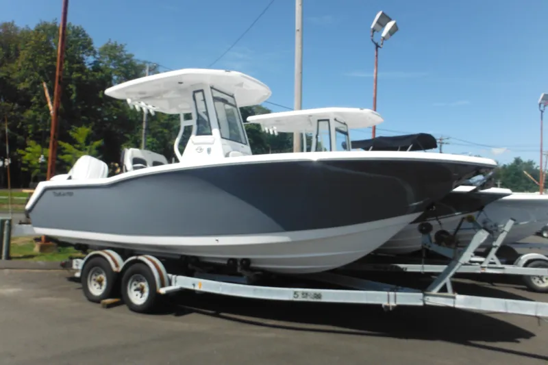 The Image of 2026 Tidewater 232 LXF boat on trailer, parked outdoors under clear sky. - 1