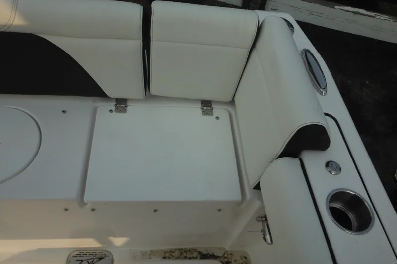 Slide: The Image of 2026 Tidewater 232 LXF boat interior seating with cup holders and storage compartment. - 15