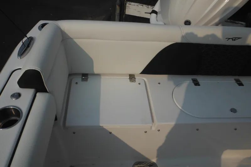 Slide: The Image of 2026 Tidewater 232 LXF boat interior seating with storage compartments. - 17
