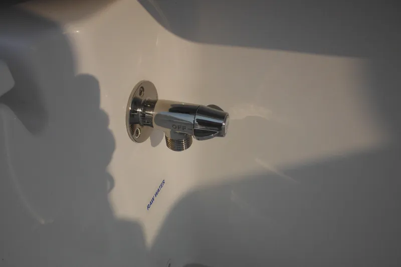 Slide: The Image of Chrome water outlet labeled "OFF" on 2026 Tidewater 232 LXF boat. - 20