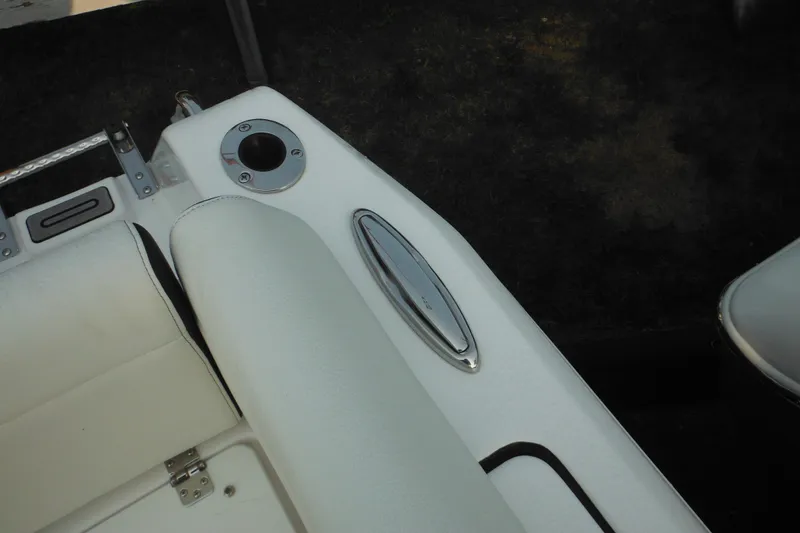 Slide: The Image of Interior view of a 2026 Tidewater 232 LXF boat, featuring white seating and a cup holder. - 22