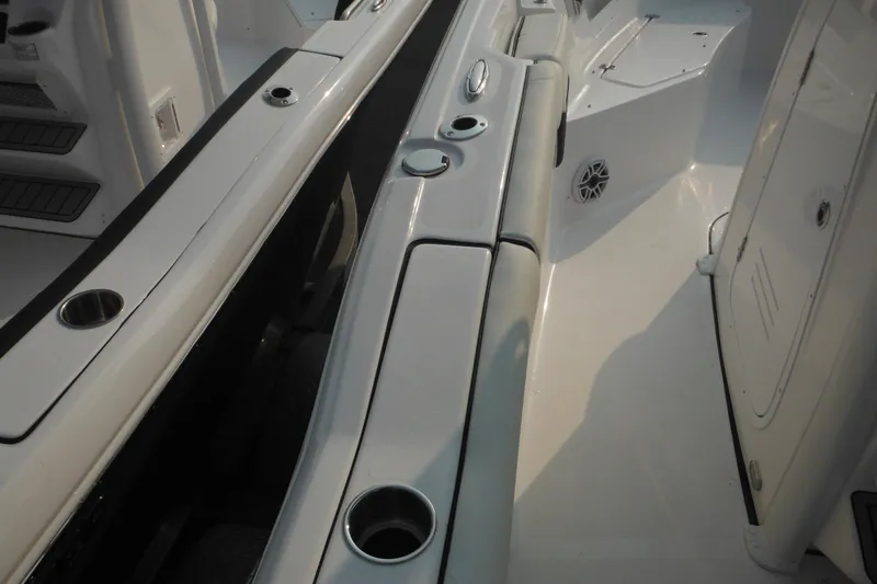 Slide: The Image of 2026 Tidewater 232 LXF boat interior with cup holders and seating area. - 23