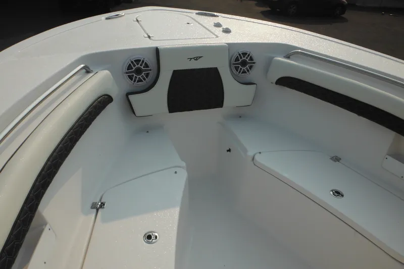 Slide: The Image of 2026 Tidewater 232 LXF boat interior with cushioned seating and built-in speakers. - 26