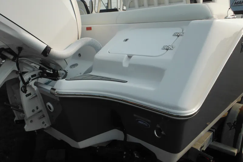 Slide: The Image of 2026 Tidewater 232 LXF boat stern with storage compartment and engine details. - 3