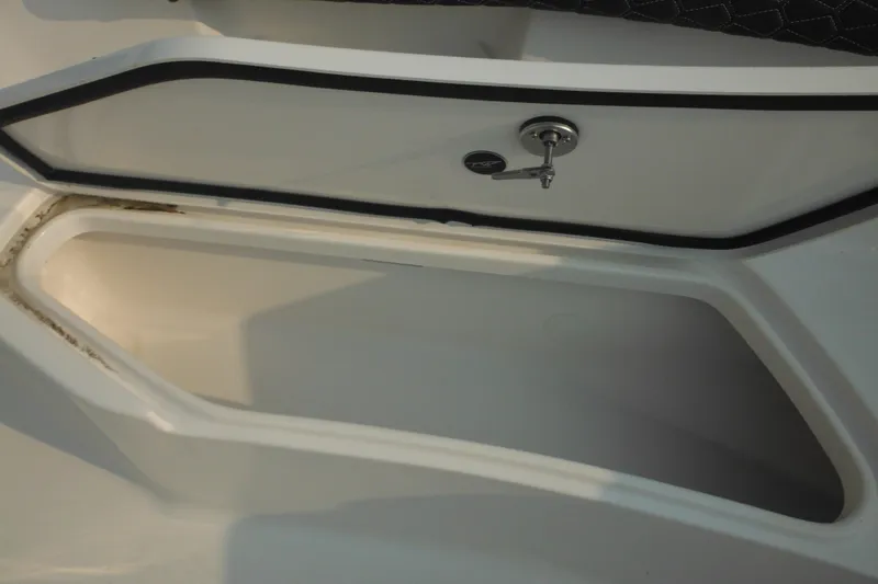 Slide: The Image of Storage compartment on a 2026 Tidewater 232 LXF boat, featuring a secure latch. - 31