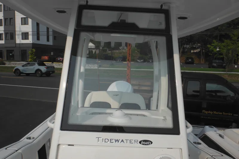 Slide: The Image of 2026 Tidewater 232 LXF boat, front view, parked near road and buildings. - 34